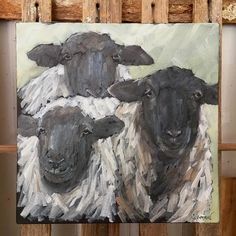 a painting of three black and white sheep