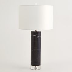 a black marble lamp with a white shade