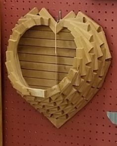 a heart shaped wooden object hanging on a wall