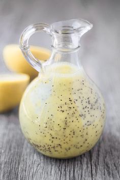 a glass pitcher filled with liquid sitting on top of a wooden table