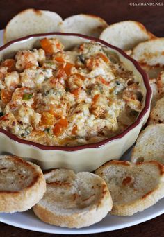 a bowl filled with food next to crackers