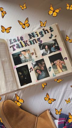 an open book with pictures of people and butterflies around it on top of a bed