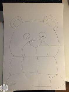 a drawing of a bear is shown on a piece of paper that has been cut out