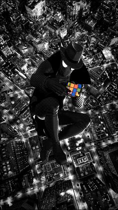 a man flying through the air while holding a rubix cube in his right hand