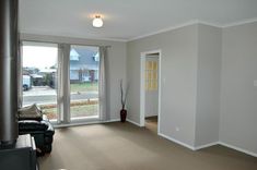 an empty living room with sliding glass doors