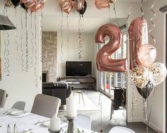 the balloons are in the shape of numbers hanging from the ceiling above the dining room table