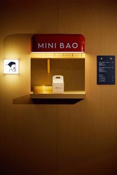 the mini bao sign is lit up on the wall