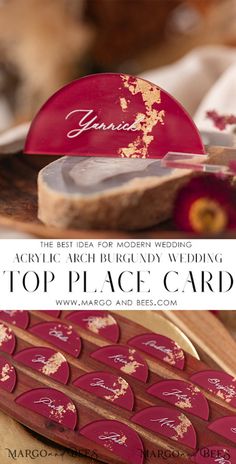 the top place card for this wedding is made from wood and decorated with gold leaf designs