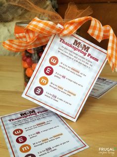 a jar filled with candy sitting on top of a wooden table next to a card