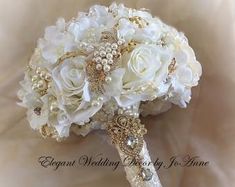 a bridal bouquet with white flowers and pearls