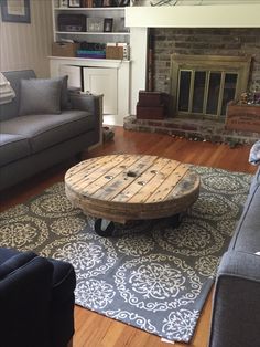 a living room with couches and a coffee table in the middle of the room