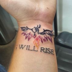 a wrist tattoo with the words i will rise written on it and an eagle in flames