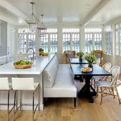 a kitchen with white cabinets and an island in front of the stove top oven is shown