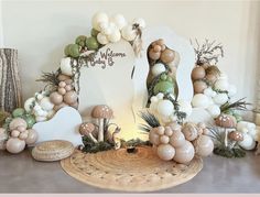 a table topped with balloons and mushrooms on top of a wooden table next to a mirror