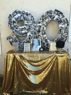 a table topped with gold sequins covered in photos and letters that spell out the word boo