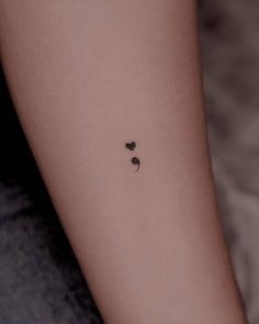 a small heart tattoo on the left inner arm, with two smaller hearts in the middle