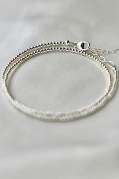 Our double wrap bracelet is one of our number one best selling bracelets. The petite double wrap beaded bracelet features a sterling silver 2mm bead that can be worn as a bracelet or a single layer choker necklace.Materials: Sterling silver beads Length: Measures an adjustable 14-15 inch length with a 2 inch extender SKU: B1182 Materials+Care Everyday Silver Single Strand Jewelry, Everyday Single Strand Silver Jewelry, Minimalist Single Strand Beaded Bracelets, Minimalist Silver Bracelets With Tiny Beads, Everyday Silver Single Strand Bracelet, Silver Single Strand Bracelet For Everyday, Dainty Silver Stackable Necklaces, Dainty Silver Stackable Necklace, Elegant Wrap Bracelet With Tiny Beads As A Gift