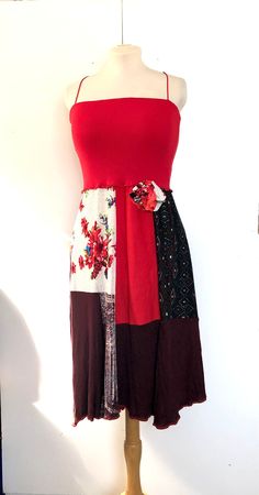 a dress on a mannequin with red, black and white colors in it