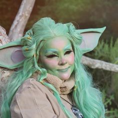 a woman with green hair and makeup is dressed as yoda from the movie star wars