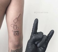 a person with a tattoo on their arm giving the peace sign and holding a black glove