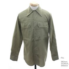 70s -PIA- Mens khaki tan polyester cotton twill work shirt with longsleeves, slightly fitted sides, rounded hemlines, buttons in front, on cuffs, and on chest patch pocket flaps, and long pointed foldover collar, almost as new, manufactured by Prison Industries, wear the shirt made by felons! Fits: 38Chest, 14.5Neck, 34Sleeve Our item # 360430-MM17841 Fitted Khaki Collared Shirt, Fitted Long Sleeve Khaki Shirt, Classic Long Sleeve Khaki Shirt, Khaki Spread Collar Shirt For Fall, Khaki Military Collared Shirt, Khaki Collared Military Shirt, Classic Long Sleeve Khaki Tops, Fitted Khaki Shirt For Fall, Retro Long Sleeve Top With Pockets