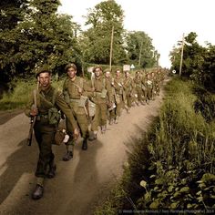 a group of men walking down a dirt road