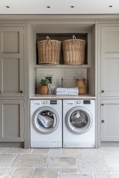 Laundry room with a washing machine and dryer side by side, baskets above, and plants on the counter. Utility In Kitchen Ideas, Small Laundry Room Ideas With Storage, Storage And Laundry Room Ideas, Utility Small Room Ideas, Boot Room Ideas Utility, Utility Room Storage Ideas Small Laundry, Contemporary Utility Room, Modern Farmhouse Utility Room, Small Utility Room Ideas Layout Floor Plans