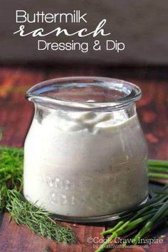 buttermilk ranch dressing and dip in a glass jar with fresh herbs on the side