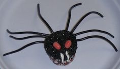 a cupcake decorated like a spider on a plate