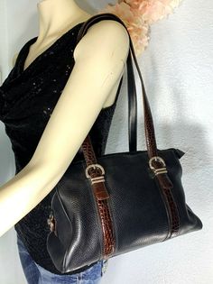 "Pre-Owned" Brighton Black Pebbled Leather with Brown Croc-Embossed Trim Purse comes with Box and Dust Bag Closure: Zip Silver-Toned Hardware Bag has a back slip pocket Approx Measurement: 12" (W) x 8" (H) x 4" (D) Strap Drop 11.5" Interior of bag has Brown satin swirl fabric that is clean with no stains, rips or odors Bag has 3 separate compartments with zipper closures, There are 3 slip pocket and 1 zippered back pocket NOTE: There is wear on the bottom corners of bag All items are accurately Office Brown Shoulder Bag With Turn-lock Closure, Brown Office Shoulder Bag With Turn-lock Closure, Brown Leather Bag With Turn-lock Closure, Croc Embossed Bag, Vintage Brighton Handbags, Pocket Notes, Black Pebbles, Brown Satin, Shoulder Bag Black