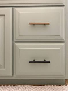 a kitchen with white cabinets and gold pulls on the drawer knobs that are brass