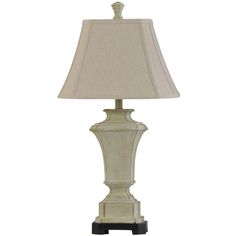 a white lamp with a beige shade on it