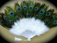 a white fan with peacock feathers on it