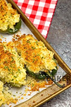 a pan filled with stuffed peppers covered in cheese