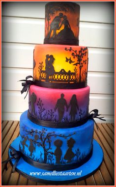 three tiered cake decorated with silhouettes of people