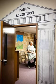 an older woman is sitting in the doorway of a building that says paul 4 adventure