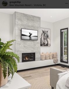 a living room filled with furniture and a fire place next to a large screen tv