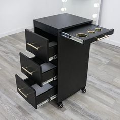 a black vanity with drawers and lights on it