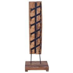 a wooden sculpture with black iron bars on it