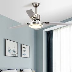 a ceiling fan in a bedroom with blue walls