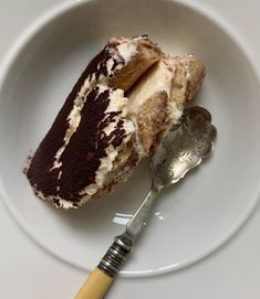 a piece of cake on a plate with a spoon