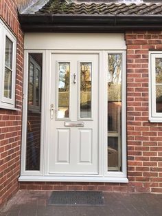 a white double door on a brick building