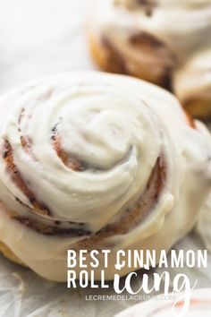 cinnamon rolls with icing sitting on wax paper