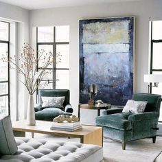 a living room filled with furniture and a painting on the wall