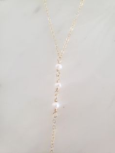 "These dainty and thoughtfully designed necklaces are stunning paired as a set or on their own! Would be wonderful for a bride or as a feminine and lovely touch to your every day. Genuine freshwater pearls are wire wrapped in a minimal/vintage-y/boho style. Made from top quality materials- true 14k gold fill or solid sterling silver, will not tarnish or turn you green, wear 24/7! Secured with an easy to use oval lobster clasp. Lead and nickel free. Excellent for sensitive skin! Come packaged in Dainty Long Backdrop Necklace With Clavicle Chain, Pearl Chain Necklace With Pearl Charm For Wedding, Pearl Drop Lariat Necklace For Wedding, Long Pearl Drop Lariat Necklace For Wedding, Feminine Gold Necklace With Pearl Drop, Wedding Pearl Drop Lariat Necklace, Dainty 14k Gold-filled Pearl Chain Jewelry, Dainty 14k Gold Filled Pearl Chain Jewelry, Elegant Lariat Jewelry For Wedding