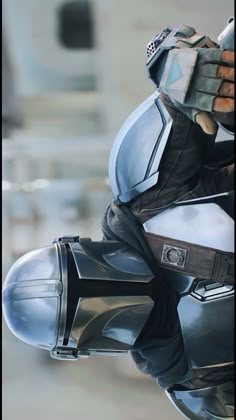 a close up of a person on a motorcycle wearing a helmet and holding something in his hand