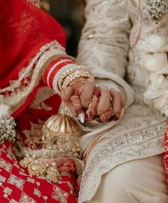 the bride and groom are holding hands with their wedding rings on top of each other