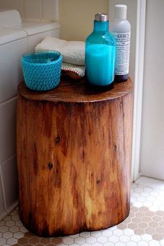 a wooden table with two bottles and soaps on it next to a bath tub