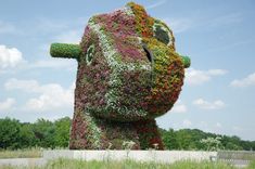 there is a very large sculpture made out of flowers in the shape of a head