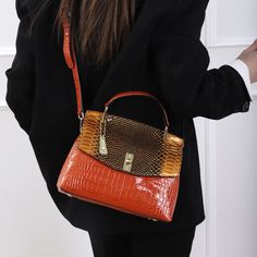 You'll be a fashion icon carrying this Versatile Atmospheric Shoulder Bag. It's perfect for every occasion and will make you stand out from the crowd. Its sublime texture and snake pattern add to its charm, turning heads wherever you go. Now available in purple and orange. Orange Rectangular Large Capacity Shoulder Bag, Orange Rectangular Shoulder Bag With Zipper, Orange Rectangular Satchel With Zipper Closure, Orange Satchel Shoulder Bag With Gold-tone Hardware, Rectangular Orange Shoulder Bag With Gold-tone Hardware, Mothers Bag, Snake Pattern, Snake Patterns, Purple And Orange